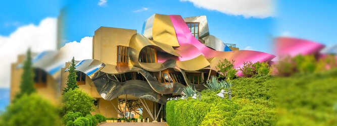 Trip Luxemburg Reisetipps - Marqués de Riscal Design Hotel, Bilbao, Elciego, Spanien. Fantastisch galaktisch, unverkennbar ein Werk von Frank O. Gehry. Inmitten idyllischer Weinberge in der Rioja Region des Baskenlandes, bezaubert das schimmernde Bauobjekt mit einer Struktur bunter, edel glänzender verflochtener Metallbänder. Glanz im Baskenland - Es muss etwas ganz Besonderes sein. Emotional, zukunftsweisend, einzigartig. Denn in dieser Region, etwa 133 km südlich von Bilbao, sind Weingüter normalerweise nicht für die Öffentlichkeit zugänglich.